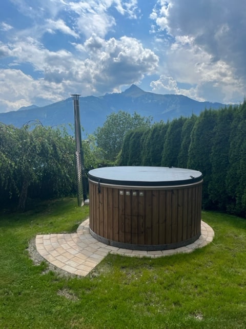 Gardenvity hot tub in backyard with mountain view.